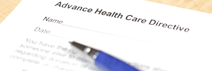 A person filling out an advance directive form.
