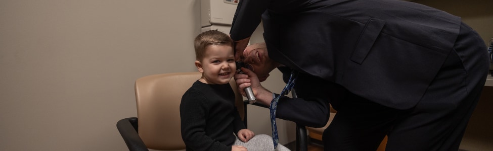 Audiologist talking to young patient 