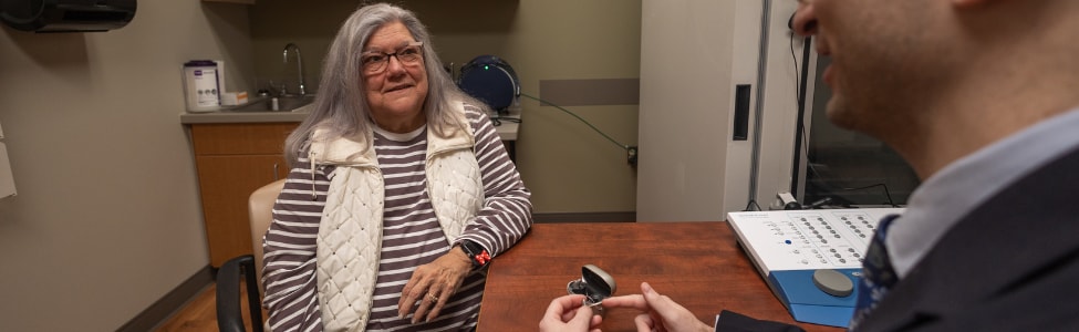 Audiologist with hearing aid patient