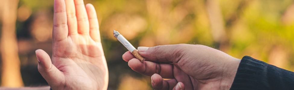 Person refusing cigarette to keep their lungs healthy