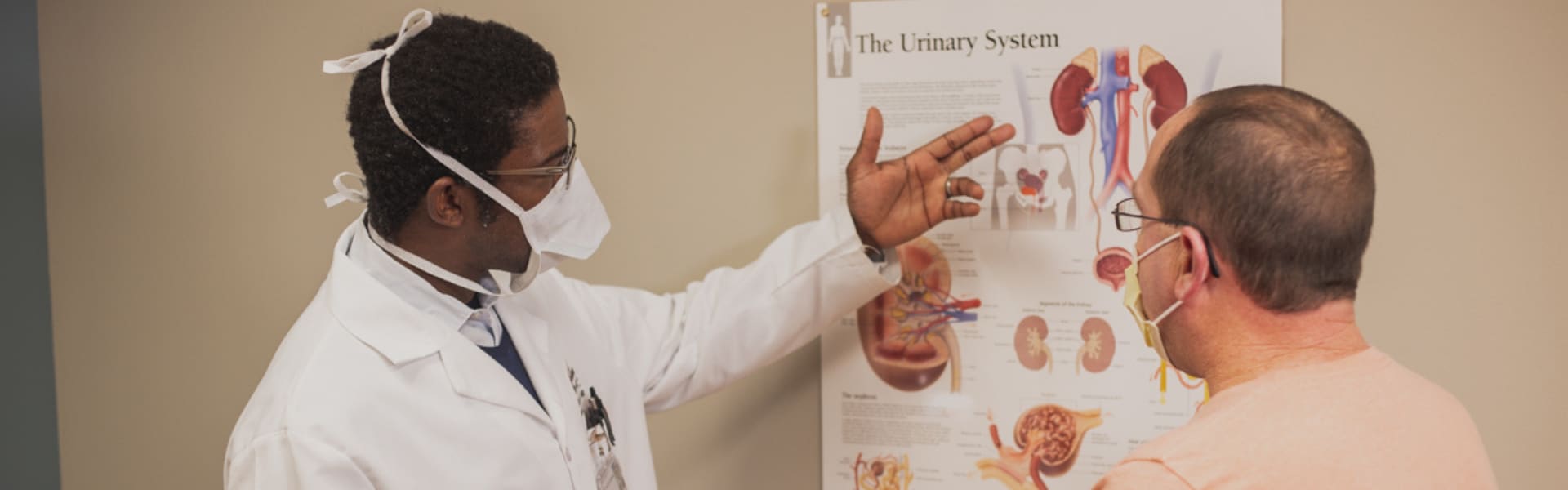 Dr. Yemi, a urologist, speaking to a patient.