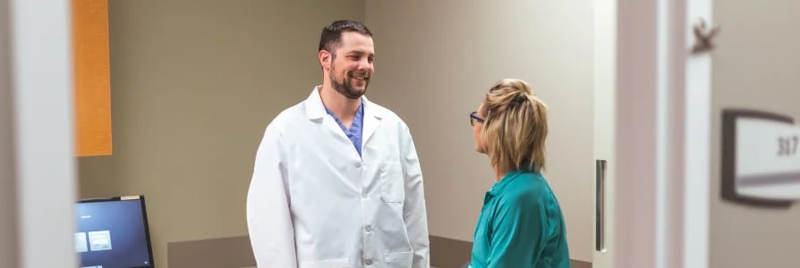Dr. Alex Laudenklos, an OB/GYN, speaking to a patient.