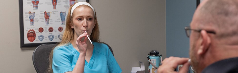 Kaylie Beach, MA, CCC-SLP with speech therapy patient