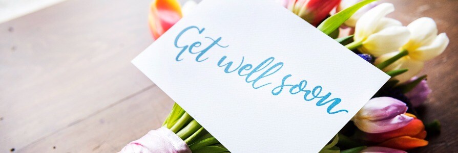 Get well soon message on a card with flowers