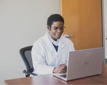 Dr. Yemi, a urologist, speaking to a patient.