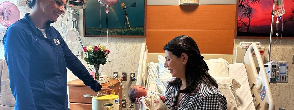 A certified lactation consultant helping a new mom breastfeed.