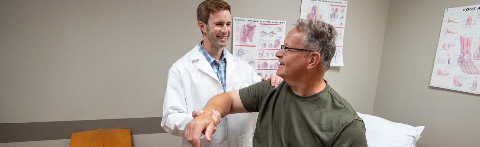 Orthopedic provider with shoulder pain patient