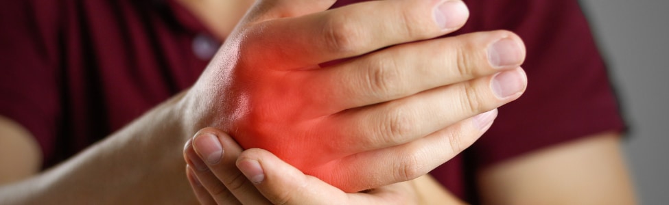 Person struggling with arthritis pain in their hand