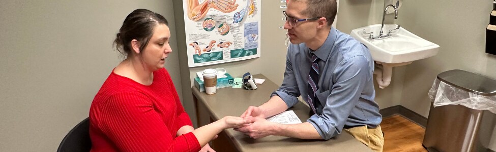 Dr. Tristan Hartzell with hand, wrist, & elbow patient