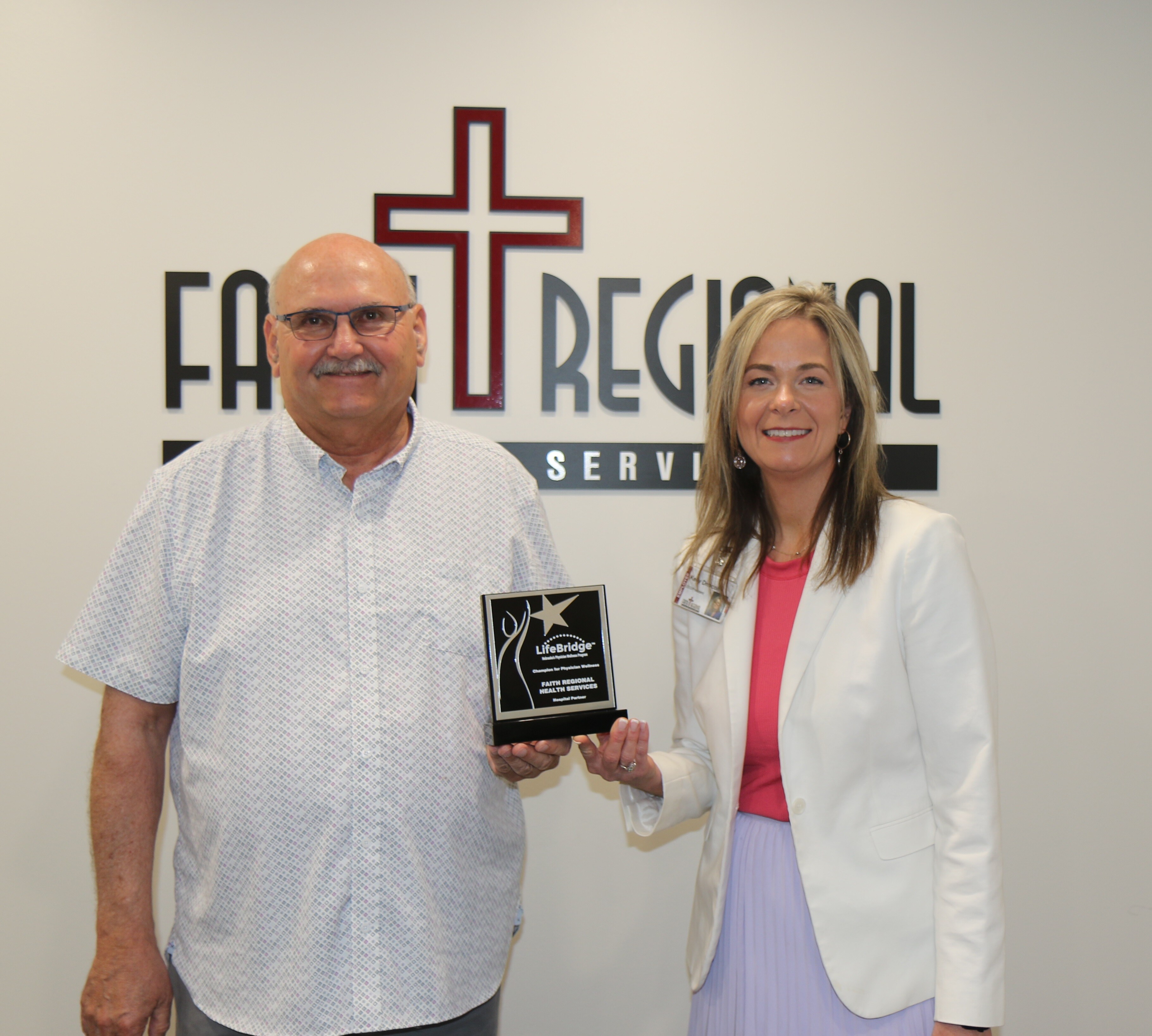 Dr. Mark Davis, Chief Medical Officer, and Kelly Driscoll, CEO, with our LifeBridge award.