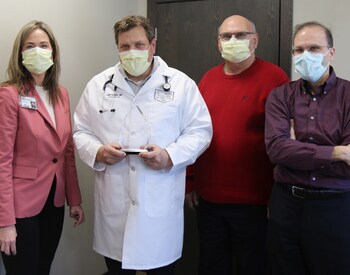 Dr. Lane Handke with his 2021 Physician of the Year award.