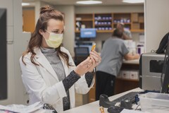 Pharmacy staff measuring out medicine