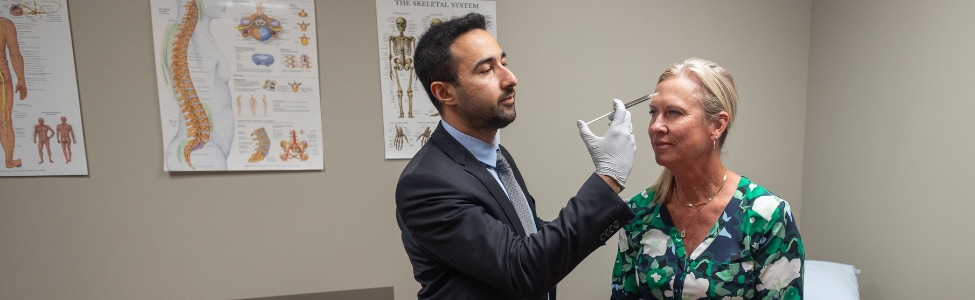 A patient in an appointment with our pain management specialist, Dr. Ihsan Balkaya 