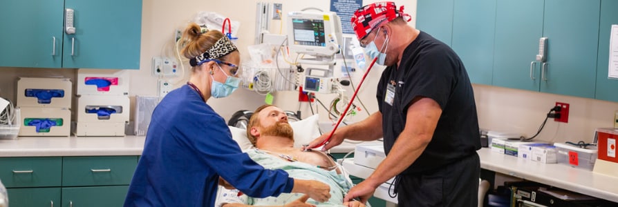 Emergency Department doctor and nurse evaluating a patient.