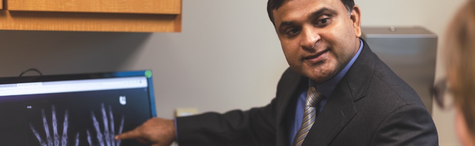 Dr. Kumar explaining hand x-ray to patient