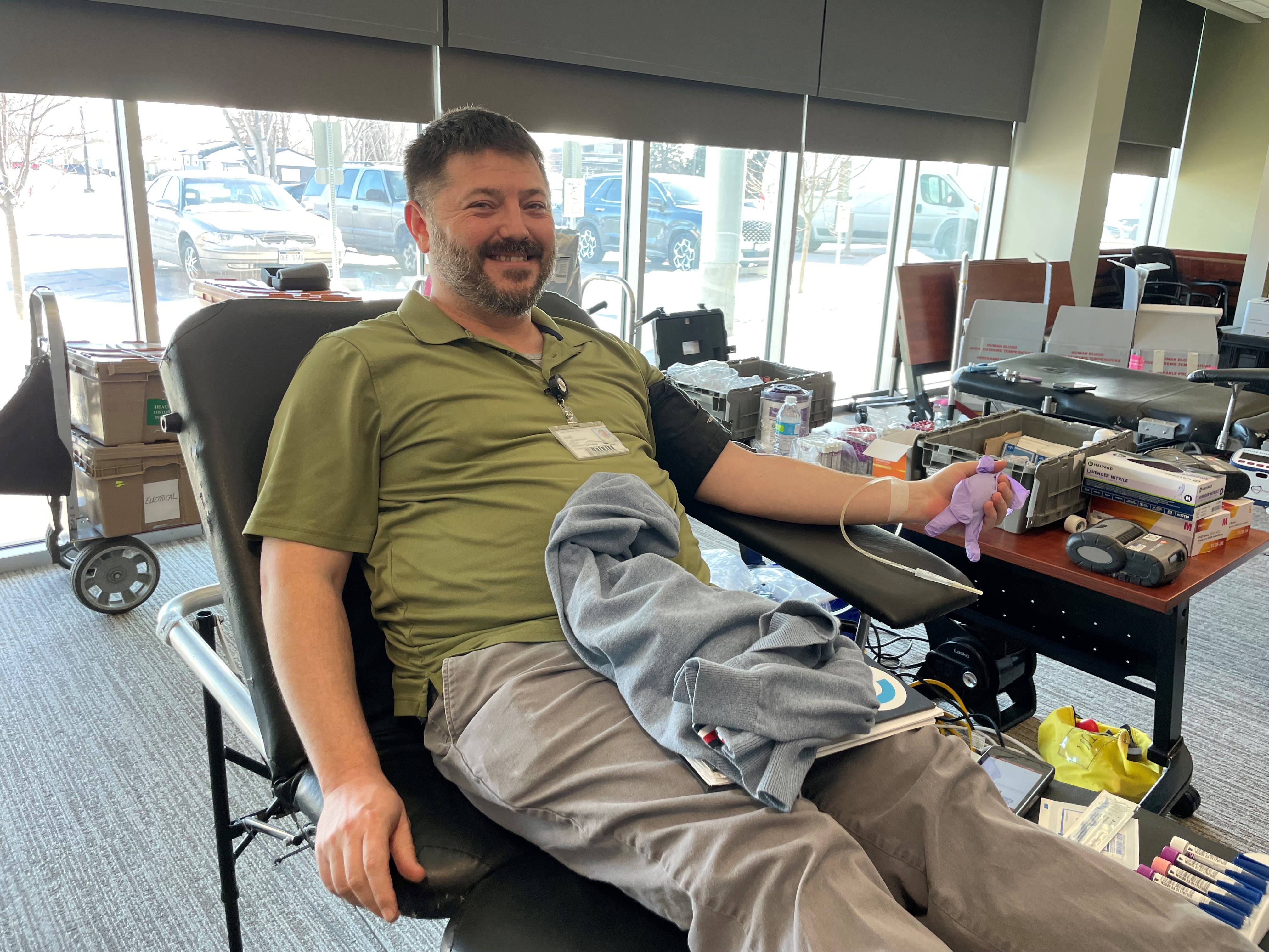 Faith Health employee donating blood during blood drive