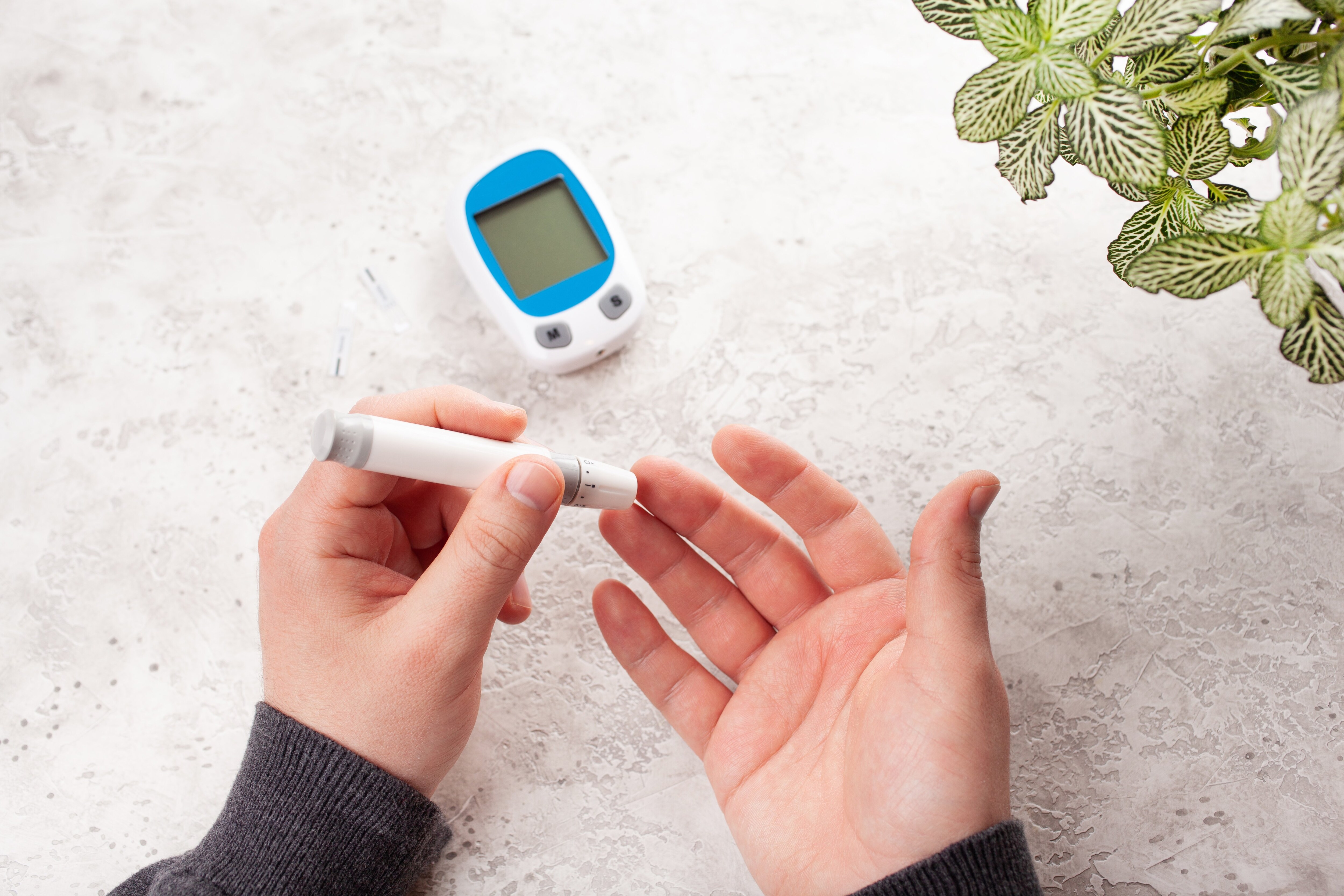 Man using lancet to measure blood sugar levels